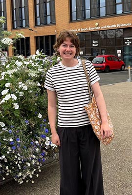 Maddie stands in front of the NCSEM building